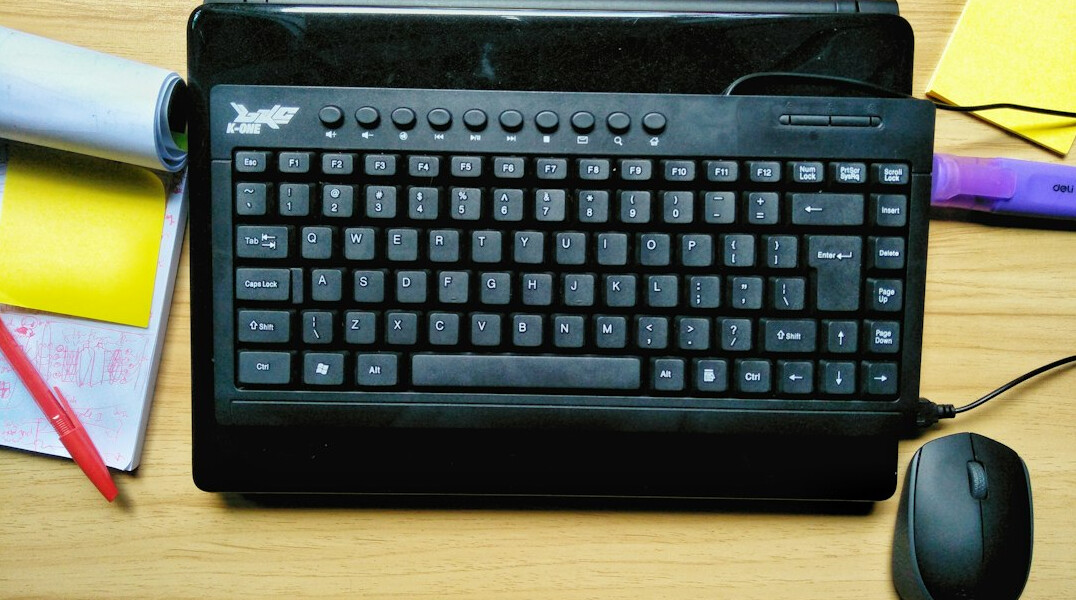 Journalist typing notes on a laptop keyboard