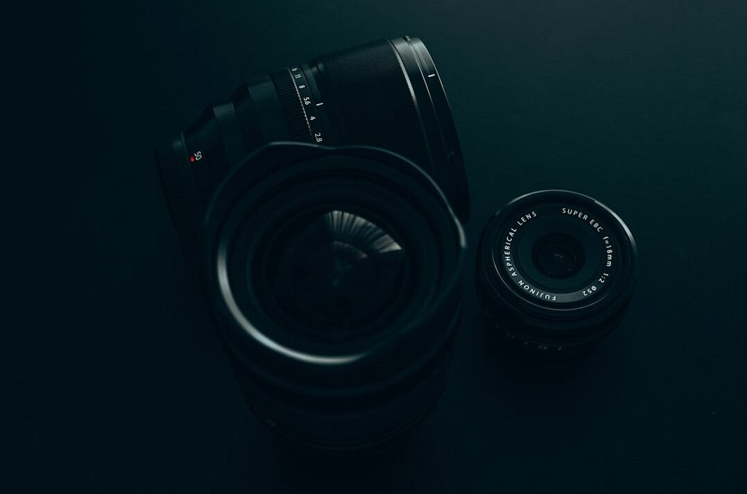 Professional camera with telephoto lens on a dark background